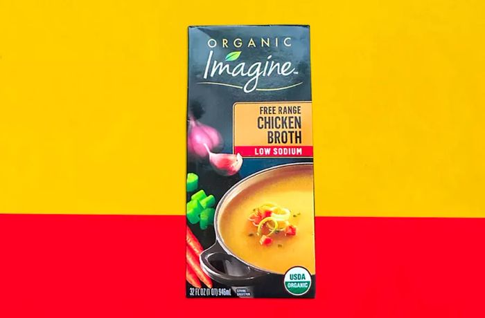 Imagine Low-Sodium Chicken Broth Box with a Yellow and Orange Backdrop