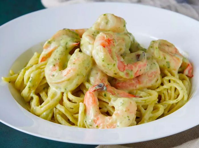 Shrimp in pesto sauce over pasta