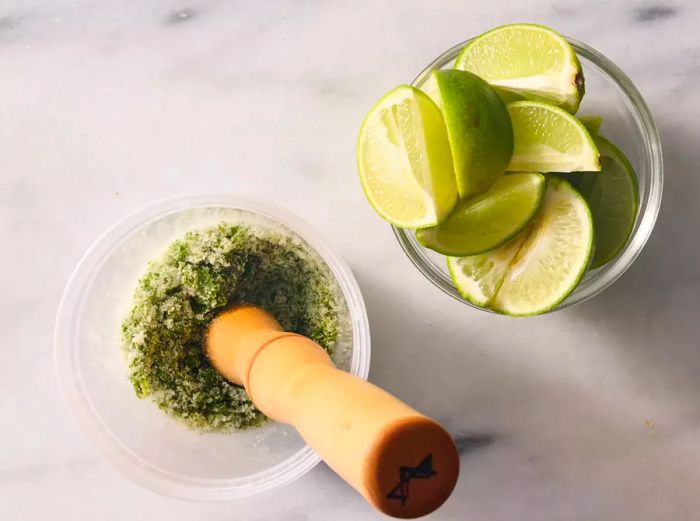 Sugar and mint leaves muddled together