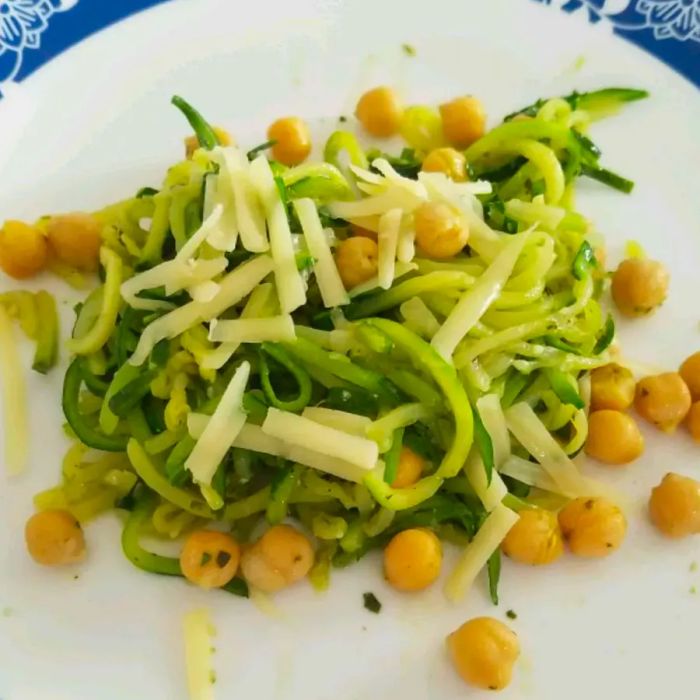 A plate of zucchini noodles topped with chickpeas