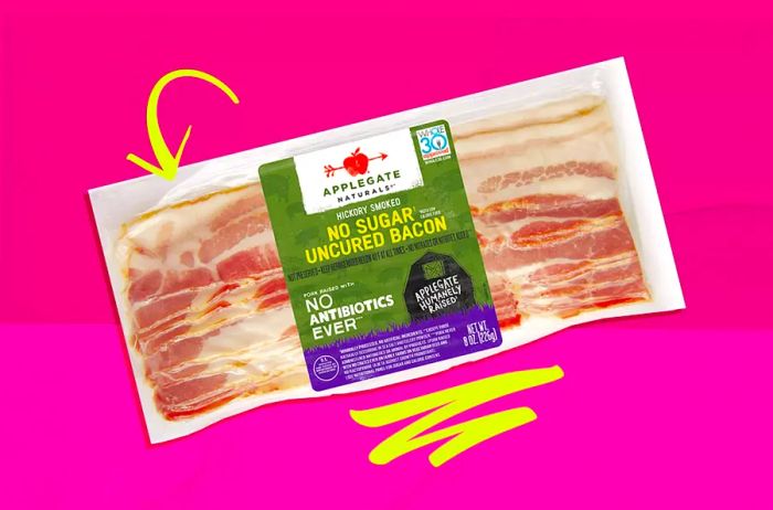 A pack of Applegate bacon against a pink background