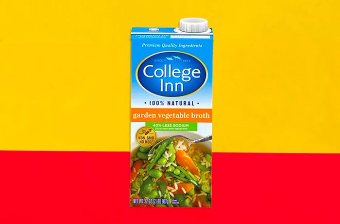 College Inn Chicken Broth Box with a Yellow and Orange Background