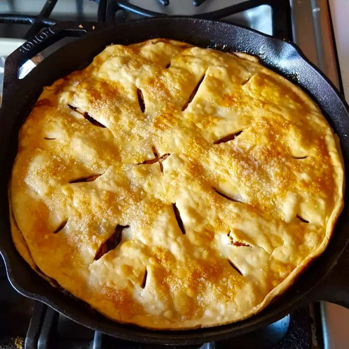 A close-up view of Grandma's Skillet Apple Pie, baked to perfection in a cast iron skillet.