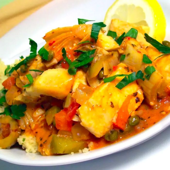 A flavorful fish stew with artichokes, olives, and lemon served over couscous