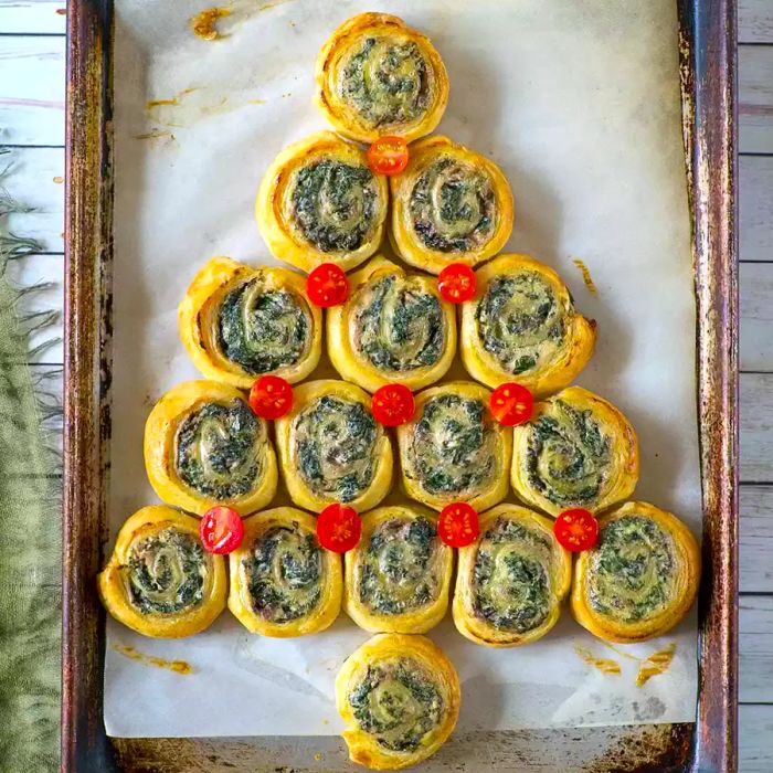 Spinach-filled puff pastries arranged in the shape of a Christmas tree.