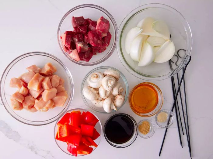 Ingredients for chicken, beef, and vegetable kabobs