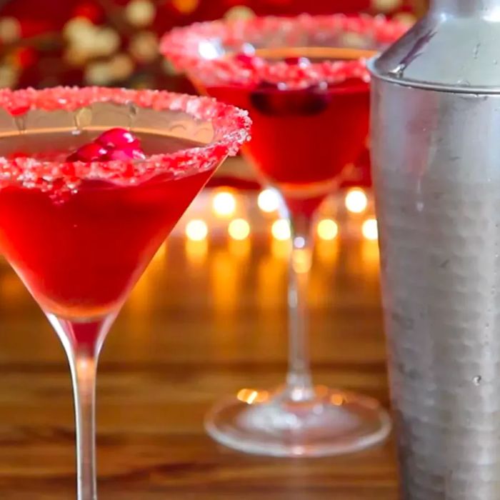 Cranberry martinis served in chilled glasses with sugared rims.