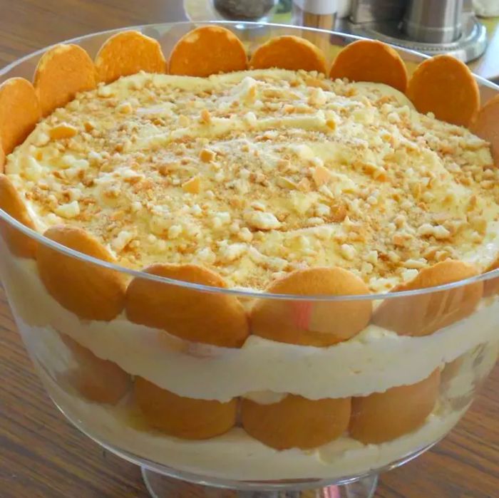 A trifle bowl filled with delicious layers of creamy banana pudding and Nilla wafers, beautifully showcasing this classic dessert.