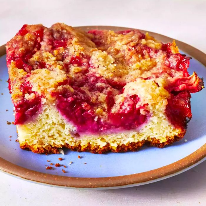 A slice of fruit-filled coffee cake topped with a crumbly streusel