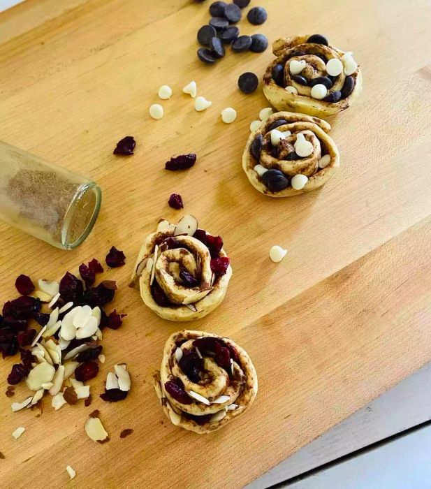 canned cinnamon rolls filled with dried fruit, nuts, and chocolate before baking