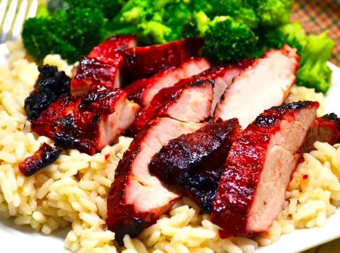 A close-up shot of Chinese BBQ Pork served with rice and broccoli