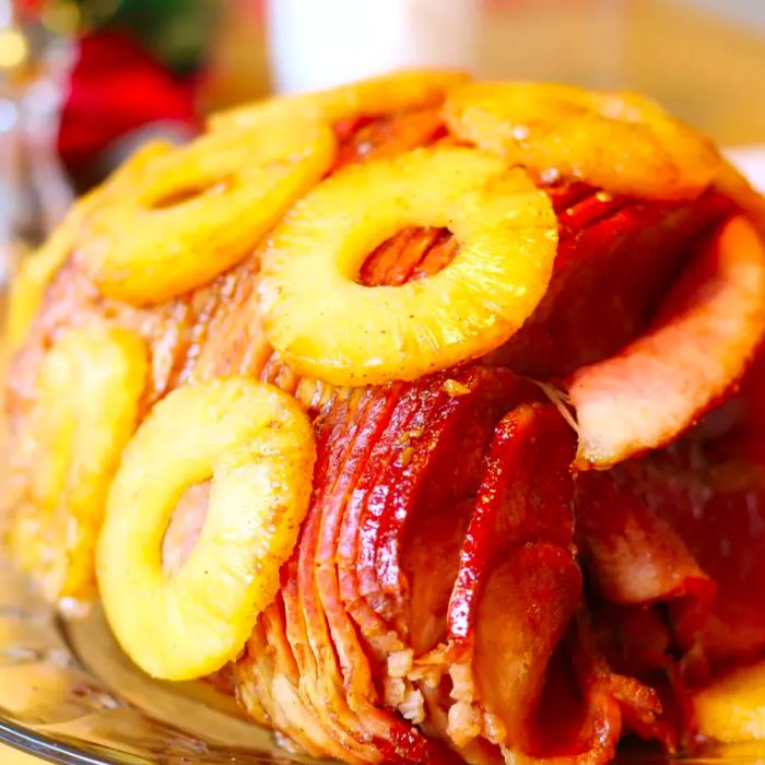 A beautifully glazed ham topped with pineapple rings.