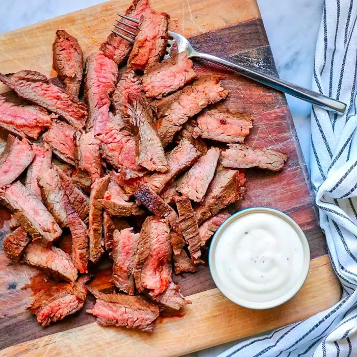 sliced flank steak on cutting board