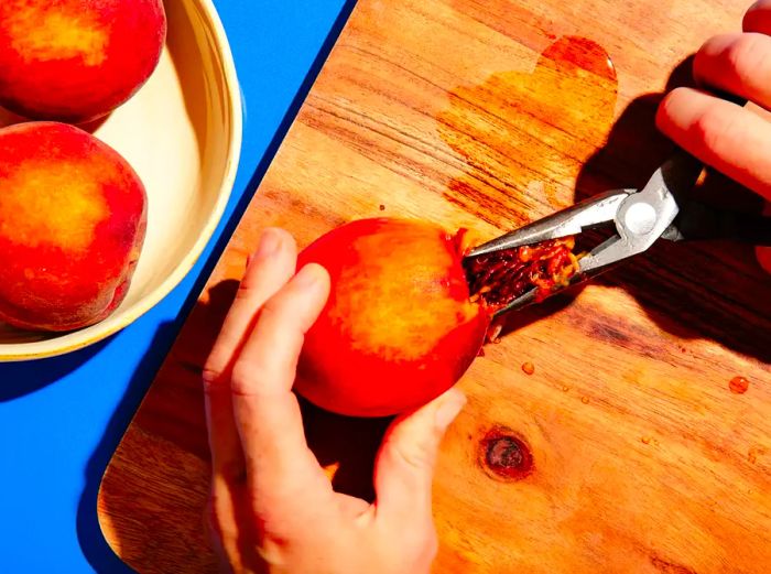 Using pliers to pull a pit from a peach.