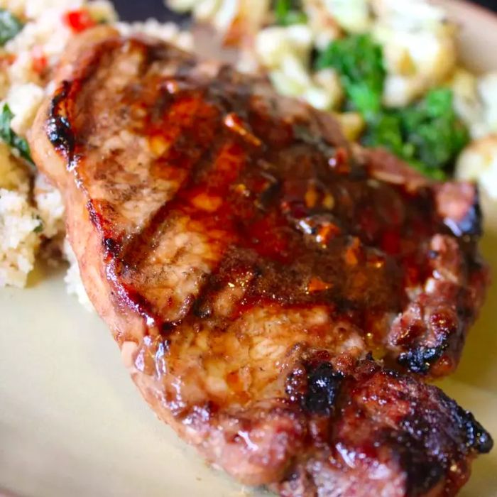 A close-up of marinated and perfectly grilled pork loin chops