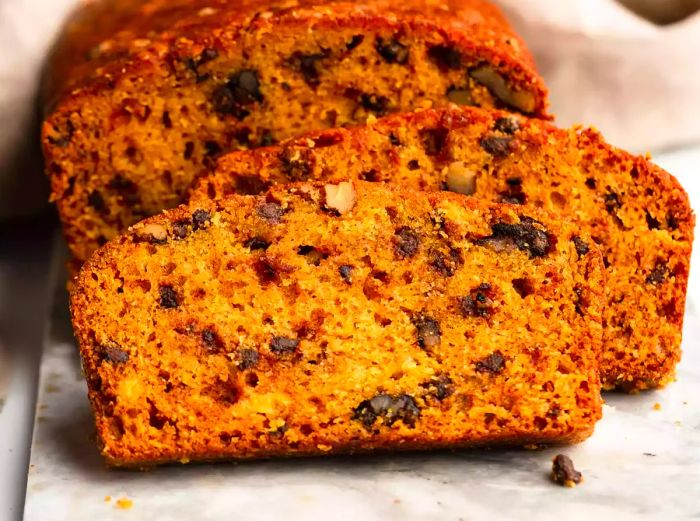 A close-up shot of a few slices of chocolate chip pumpkin bread