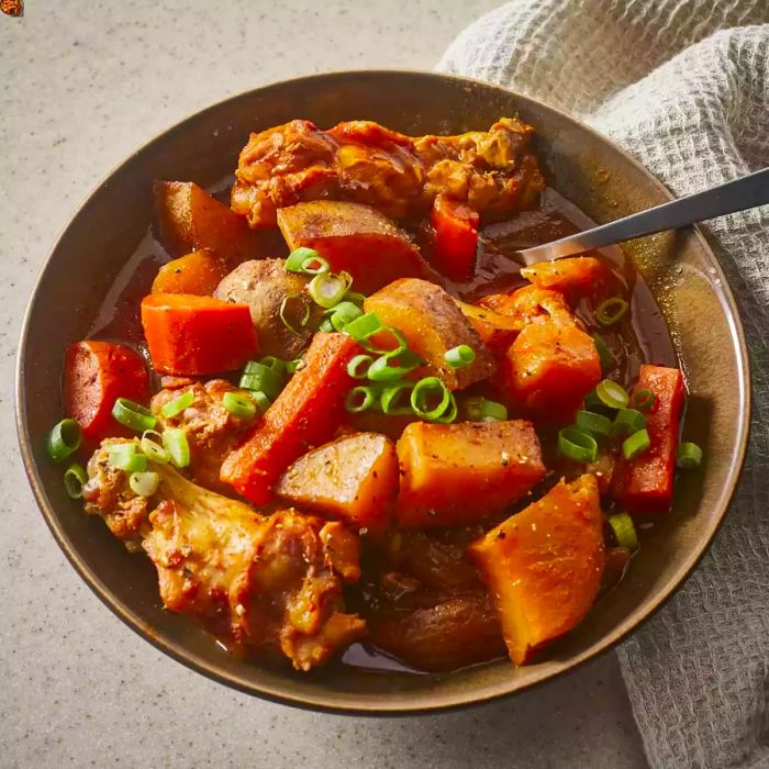 Korean-style spicy chicken and potatoes in a brown bowl