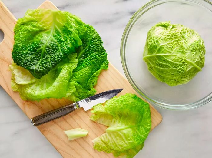 A top-down view of cabbage leaves being prepped for stuffing.