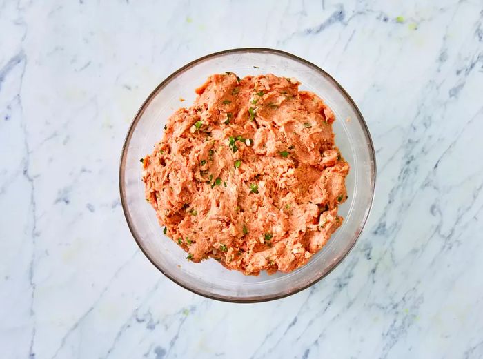 A top-down view of the mixed turkey burger ingredients in a bowl.