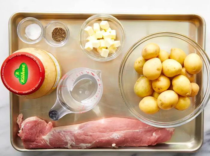 All ingredients are ready to prepare the slow cooker pork and sauerkraut dish.