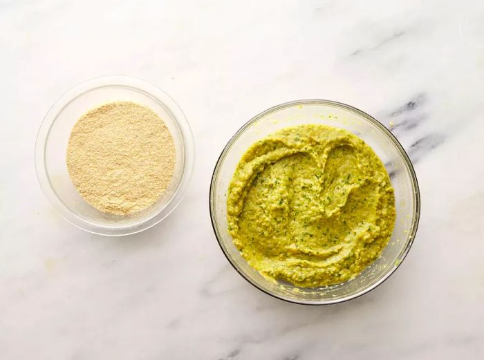 Aerial view of falafel mixture and breadcrumbs placed in separate bowls