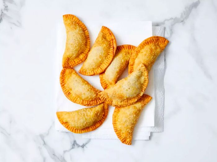 Fried beef empanadas resting on a layer of paper towels