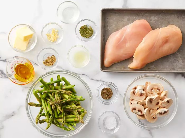 An aerial shot of all the ingredients for the chicken, asparagus, and mushroom skillet.