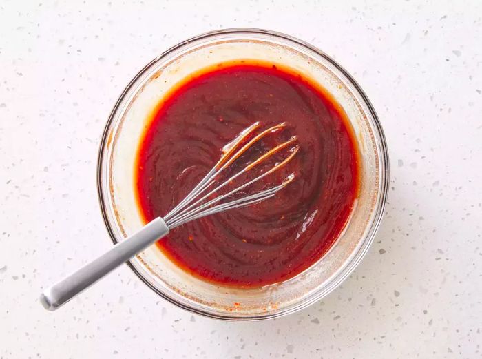 A bowl of barbecue sauce being mixed together.