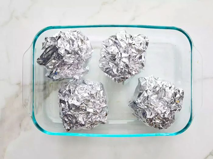 Artichokes securely wrapped in foil.