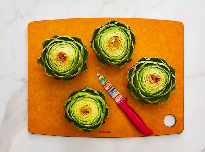 Leaves slightly spread apart with a garlic clove-sized hole created in the center of the artichokes.