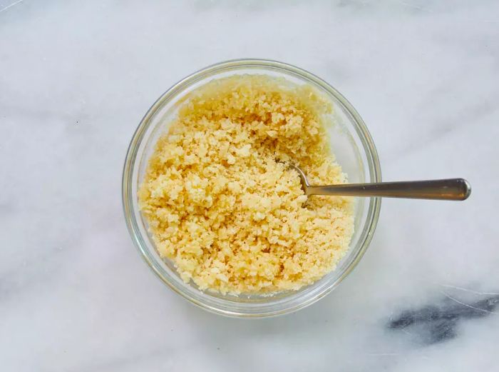 A bowl of panko breadcrumbs mixed with melted butter.