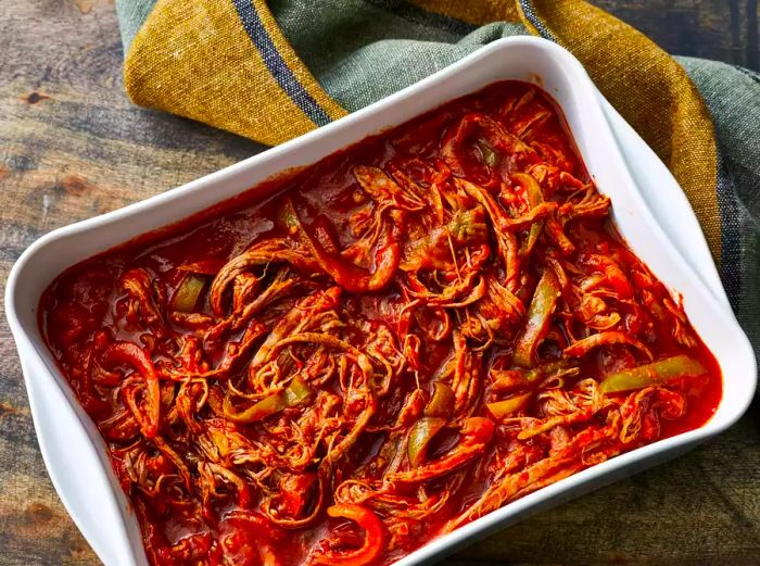 A top-down view of a casserole dish filled with Cuban Ropa Vieja.