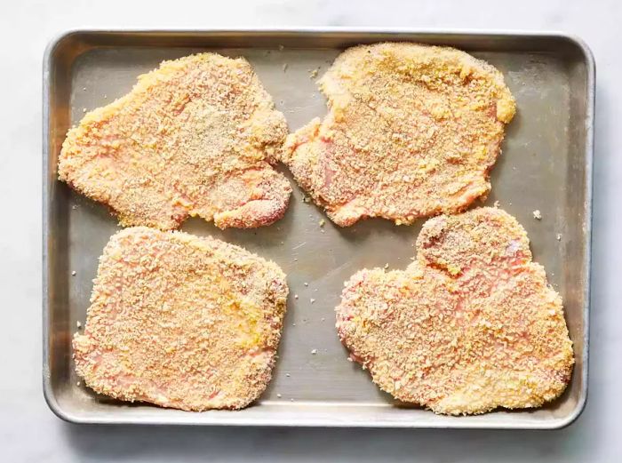 Coat the chicken cutlets on a prepared baking sheet.