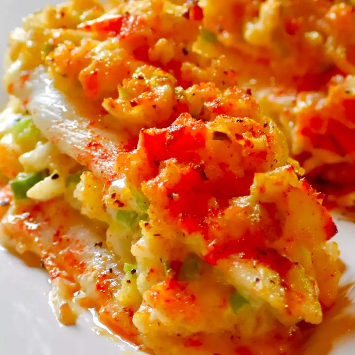 Close-up image of Crab-Stuffed Sole fillets arranged on a white platter.