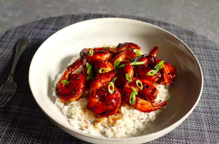 Honey Garlic Shrimp served on rice, presented on a white plate