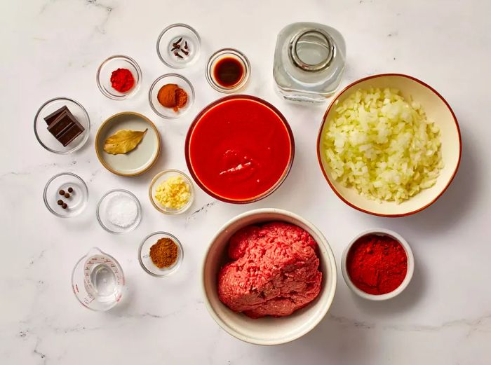 The ingredients for Cincinnati chili neatly arranged on a clean white surface.