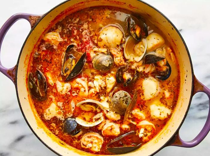 Mussels and shrimp cioppino cooking in the pot.