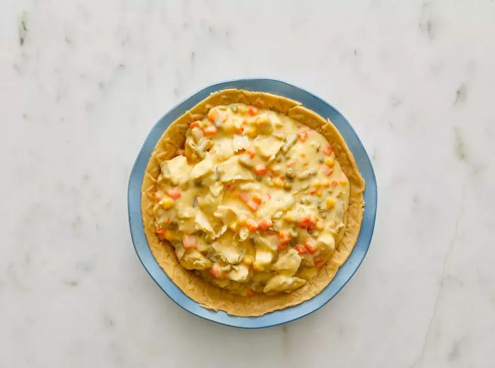 Bird's-eye view of the pot pie filling poured into the crust.