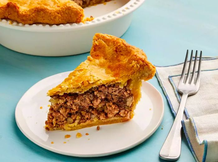 A plated slice of Tourtière (French Canadian meat pie)