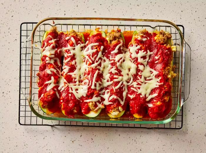 Baked stuffed zucchini cooling on a wire rack