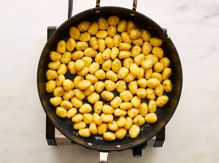 Gnocchi added to the skillet with the other ingredients, tossed gently to mix together.