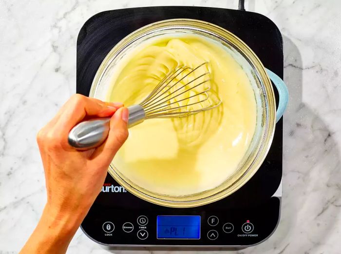 Continue whisking until the hollandaise thickens and the ingredients are fully combined.