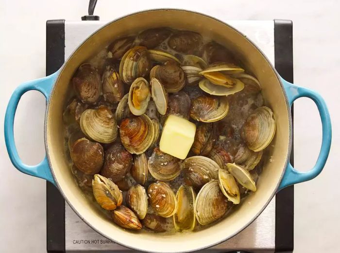 Butter stirred into the steaming clams.