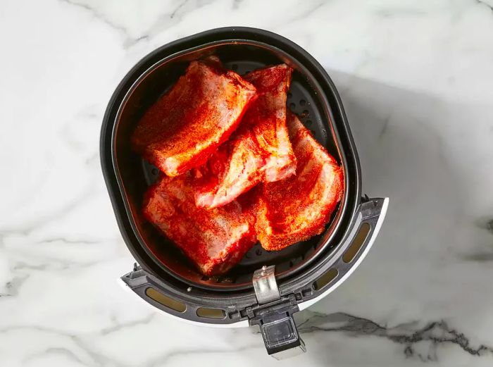 Place the ribs into the air fryer basket.