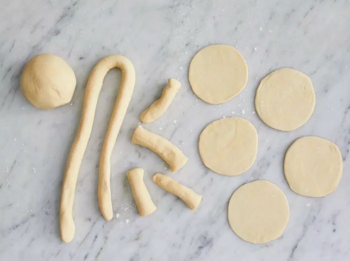 Overhead shot of dough being flattened into circles for pot stickers.