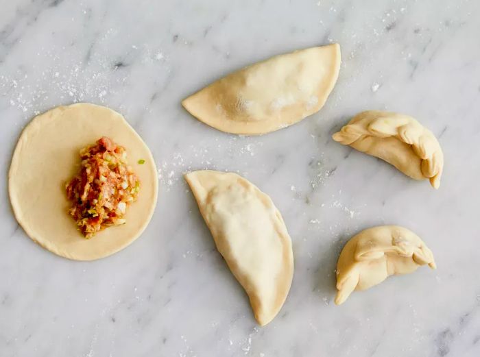 Overhead view of the filling being added to the dough for pot stickers.