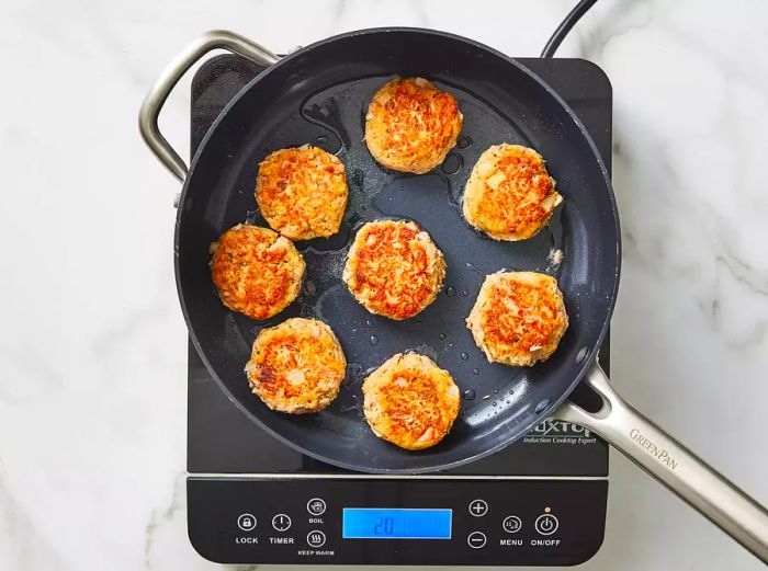 frying the patties in hot oil until both sides are golden brown