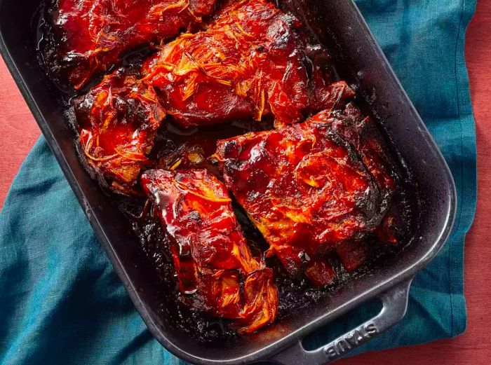 Oven-Baked BBQ Ribs resting in a roasting pan