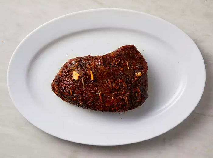 Cooked top sirloin served on a white plate