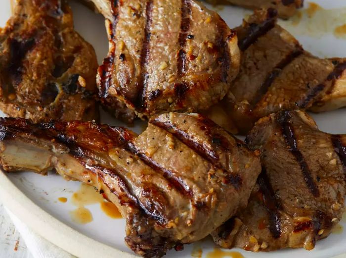 A close-up view of a plate filled with grilled lamb chops